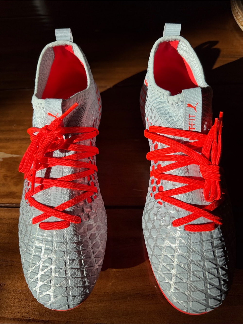 Puma Silver Knit Soccer Cleats with Orange Accents